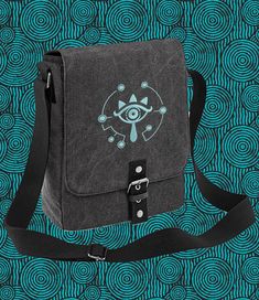 Looking to level up your storage? Need to carry a bit more inventory? This canvas tablet / iPad messenger bag with a luminous embroidered Sheikah eye design from the Legend of Zelda will definitely do just that. You don't even need to trade korok seeds for it, plain old currency will do! Not only is the design EXTREMELY cool, but it also GLOWS IN THE DARK!! You can choose white, pale blue or pale green thread (colour visible in the light, in the dark they pretty much glow the same colour). We're Green Thread, Tablet Bag, Zoom Call, Ipad Tablet, Eye Design, Pale Green, Legend Of Zelda, Magnetic Closure, Pale Blue