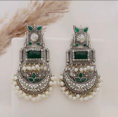 These beautiful statement emerald green dangler earrings will compliment any outfit! Made in high quality German silver, these are light weight and easy to wear.  For any queries, please feel free to contact us. Happy shopping! Heavy Green Chandbalis For Party, Green Heavy Chandbalis For Party, Heavy Green Earrings For Festive Occasions, Fusion Style Green Chandbalis For Gift, Fusion Style Green Chandbalis As Gift, Festive Green Chandelier Earrings For Party, Festive Green Chandbalis For Party, Elegant Green Danglers For Festive Occasions, Green Chandbali Bridal Earrings With Latkans