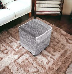 a box sitting on top of a rug in a living room