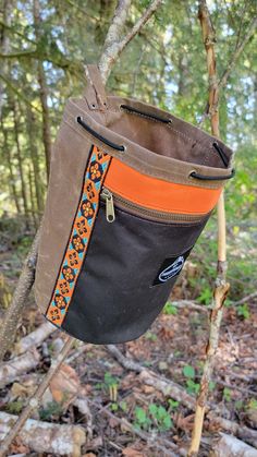 Do you need an awesome bag to hold your gear? Do you love a handcrafted waxed canvas piece of gear? Then our Two Tone Bucket Bag in Brown and Black is perfect for you. This waxed canvas round-bottomed bag has a 6.5' diameter and is 9.5" tall. The bag closes with a paracord and a toggle. This bag is perfect for holding all kinds of gear or for packing your favorite snacks. This one is a bit special because we added a zipper pocket to the front and vintage woven trim with a pop of orange. this is a one of a kind bucket bag. It even has a leather loop so you can hang it open. Each bag is designed, created and assembled in our small shop in the beautiful Pacific Northwest. No two bags are exactly alike but all are made with great care and the intent that the item will be with you for a long ti Canvas Bucket Bag, Waxed Canvas Bag, Bucket Bags, Bag Ideas, Waxed Canvas, Fun Bags, Pacific Northwest, Paracord, Small Shop