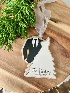 a wooden ornament with a bride and groom's wedding date on it