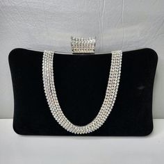 For a more sophisticated take on the classic clutch bag, the Velvet Flask Dinner Bag is sure to please. It features a flask shape design, embellished with an array of sparkling crystals, and an elegant clasp closure. Available in red and black. This elegant clutch bag adds just the right amount of glitz to make any outfit shine! Elegant Crystal Embellished Clutch For Cocktail, Evening Handheld Clutch With Rhinestones, Handheld Rhinestone Clutch For Evening, Cocktail Clutch Bag With Chain Strap, Cocktail Clutch Bags With Chain Strap, Luxury Silver Bags For Cocktail, Clutch Bags With Chain Strap For Cocktail, Elegant Pouch Clutch With Chain Strap, Chic Clutch Evening Bag With Rhinestones