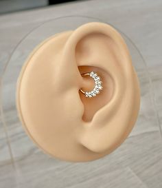 an ear with a diamond ring on top of it