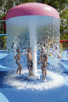 two children playing in the water at a splash park