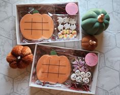 two boxes filled with different types of buttons and candies on top of a table