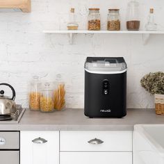 a black and silver ice cream dispenser sitting on top of a counter