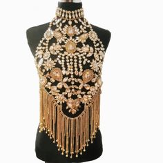 Introducing the Luxury Rhinestone Chain Shirt from Primadons and Donnas. This stylish and innovative shirt is sure to turn heads. It features a full rhinestone chain front and a halter style in the back. It's the perfect way to make a statement and stand out from the crowd. This shirt is made from high-quality materials and is designed to last. Plus, it ships in just 1 business day, so you can get it fast. So don't wait, get your Luxury Rhinestone Chain Shirt today and show off your unique style Elegant Crystal Body Chain For Festivals, Glamorous Festival Body Jewelry In Crystal, Glamorous Festival Body Jewelry With Crystal, Glamorous Festival Crystal Body Jewelry, Glamorous Crystal Body Jewelry For Festivals, Glamorous Crystal Body Chain, Glamorous Gold Crystal Body Chain, Glamorous Festival Body Jewelry With Bling, Glamorous Bling Body Jewelry For Evening