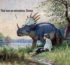 two children are sitting next to a dinosaur