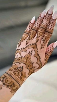 a woman's hand with henna on it