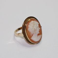 SKU: 0057 A beautiful cameo fancy ring set in 14ct yellow gold. This pretty ring would be perfect for any and every occasion. Size: UK: K 1/2 American: 5 1/2 Continental: 10 1/2 This is a vintage item and such has wear. There may be some superficial scratches, otherwise the item is good condition. This item comes beautifully boxed in our own packaging. Processing time for orders is 1-3 business days. Vintage 14k Gold Cameo Rings, Classic Oval Cameo Rings, Yellow Gold Cameo Ring Fine Jewelry, Vintage Yellow Gold Cameo Rings, Cameo 14k Gold Rings For Collectors, Classic Cameo Yellow Gold Rings, 14k Gold Cameo Ring Fine Jewelry, Collectible 14k Gold Cameo Rings, 14k Gold Cameo Rings For Collectors