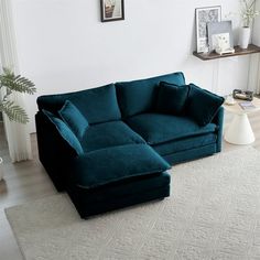 a blue couch sitting on top of a white rug