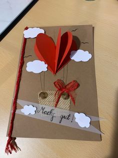 a handmade card with a heart shaped balloon attached to the back of it that says, naff gut