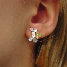 "Sterling silver and 18k yellow gold flowers assembled from a random selection of the highly detailed 'teeny' and 'tiny' blossoms that I make. They are arranged in a random but similar pattern then finished with nickel free sterling silver heavy weight posts and ear nuts. I make each flower of solid sterling silver and solid 18k yellow gold, once they are assembled, I give them a satin finish and then lightly burnish and polish the tiny veins for contrast. They measure 5/8\" long (16.2mm) and 1/ Yellow Gold Sterling Silver Pierced Flower Earrings, Pierced Yellow Gold Flower Earrings In Sterling Silver, Delicate Sterling Silver Yellow Gold Earrings, Sterling Silver Flower-shaped Cluster Earrings For Pierced Ears, Sterling Silver Flower Shape Cluster Earrings, Delicate Sterling Silver Cluster Earrings For Anniversary, Tiny Fine Jewelry Earrings For Wedding, Dainty Gold Cluster Earrings In Sterling Silver, Gold Sterling Silver Cluster Earrings