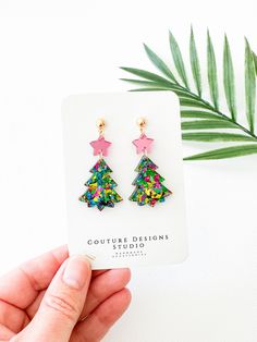 These bright glitter Christmas Tree Earrings are lightweight and such a fun way to celebrate the holiday season! They are made using acrylics that include hot pink mirrored stars and green multi colored flake glitter trees. The total length of these earrings measure 2 inches long and 1 inch wide. They are set using your choice of Stainless Steel Gold or Silver ball posts with clear silicone backings OR lead free and nickel free ear wires (suitable for even sensitive ears) in either a Silver, Gold, Gunmetal or Antique Gold finish. Each pair of earrings come shipped attached to an earring card and sealed in their own clear packaging. All earrings purchased from my shop ship in a box so they arrive safely to you. Pink Earrings For Christmas Party, Glitter Christmas Tree, Clear Packaging, Sparkly Eyes, Earring Card, Holiday Earrings, Tree Earrings, Christmas Tree Earrings, Earrings Christmas