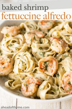 shrimp fettuccine alfredo in a white bowl with text overlay that reads baked shrimp fettuccine alfredo