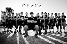 a group of people standing next to each other in front of a soccer field with the words ohana on it