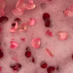 rose petals and petals on the ground with pink water in it's bottom half