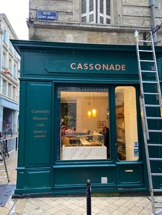 a store front with a ladder leaning up against it