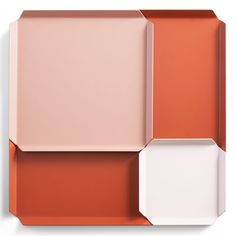 an orange, white and pink plate with two different shapes on the top one is empty