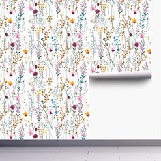 the wallpaper is decorated with colorful flowers and plants on white walls, along with a window