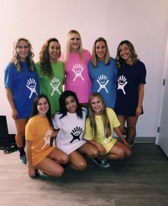 a group of women in matching shirts posing for a photo