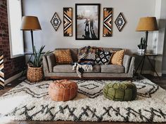 a living room filled with furniture and pictures on the wall