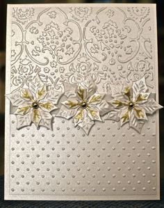 a white card with gold flowers on it