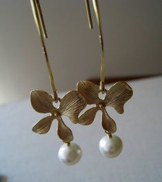 these simply elegant earrings feature lustrous round pearls dangle from orchid flower component. vermeil long earwires. 2.1''long.Looking for silver version of the earrings~http://www.etsy.com/listing/56579374/pearl-silver-orchid-earrings-bridalPlease convo me if you would like to customize this piece or order multiples for your bridal party , I would love to hear from you! Elegant Flower Earrings With Lever Back For Anniversary, Elegant Floral Earrings With French Hook, Elegant Flower Shaped Earrings With French Hook, Elegant Flower Earrings With French Hook, Elegant Gold Flower Shaped Pearl Earrings, Elegant Gold Flower Pearl Earrings, Elegant Gold Flower-shaped Pearl Earrings, Elegant Dangle Flower Earrings With French Hook, Elegant Pearl Earrings With French Hook For Wedding