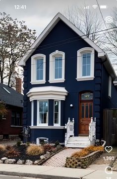 a blue house with white trim and windows