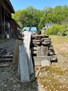 a pile of wood sitting next to a building