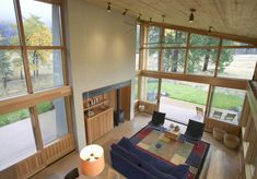 a living room filled with furniture and lots of windows