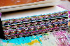 a stack of colorful papers sitting on top of a table