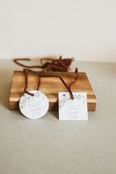 two tags are attached to a wooden box with twine and string on the top