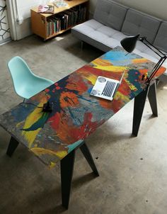 a laptop computer sitting on top of a wooden table next to a couch in a living room