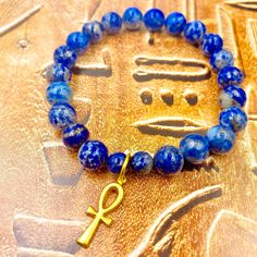 Adorn Yourself with these simple yet powerful gemstone bracelets w/ Brass Ankh Charm. Perfect as a gift, for stacking and everyday wear. 8MM Gemstone 1/2 Inch Brass Ankh Charm and non-tarnish 18k Gold Connector Ring. Fits Size 7 1/2 Wrist Gift Lapis Lazuli Bracelets With Round Beads, Gift Lapis Lazuli Round Bead Bracelets, Lapis Lazuli Bead Bracelet Gift, Spiritual Stackable Charm Bracelet, Adjustable Stackable Spiritual Charm Bracelet, Adjustable Lapis Lazuli Crystal Bracelet Gift, Lapis Lazuli Gemstone Beads Bracelets As Gift, Spiritual Stackable Charm Bracelet With Round Beads, Lapis Lazuli Gemstone Beads Bracelet For Gift