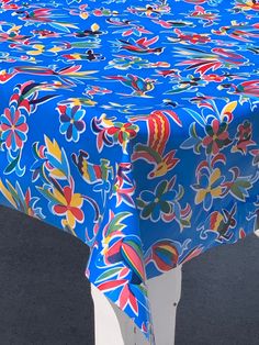 a blue table cloth with colorful flowers on it