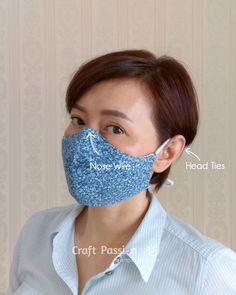 a woman wearing a blue face mask with words on it