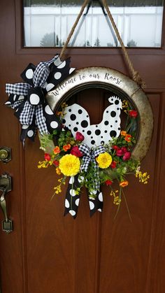 a dalmatian wreath hanging on the front door with flowers and ribbon around it