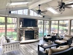 a living room filled with furniture and a flat screen tv mounted to the wall next to a fire place