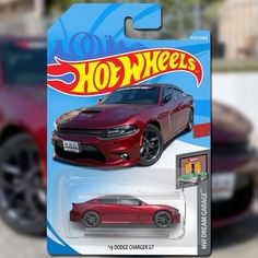 a red dodge charger car with hot wheels on it's front and side