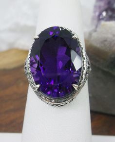 Natural Purple Amethyst Ring Persian Design#230 Custom Made This is a brand new stunning Art Nouveau/Vintage designed sterling silver filigree 10.54ct oval Natural Purple Amethyst ring. The Flawless oval full cut high-quality Amethyst is 18mm (just shy of 3/4th of an inch) by 13mm (1/2 inch) in dimension... This ring is 21mm North South on the finger. The inside of the band is marked 925 for sterling. Notice the beautiful filigree swirl like the craftsmanship of the silver setting. This lovely r Classic Large Stone Amethyst Ring For Formal Events, Classic Oval Purple Gemstones, Classic Formal Amethyst Ring With Large Stone, Classic Purple Oval Gemstones, Purple Oval Classic Gemstones, Antique Oval Purple Amethyst Ring, Antique Oval Amethyst Ring, Oval Amethyst Collectible Ring, Victorian Style Oval Purple Amethyst Ring