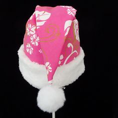 "This novelty tropical Santa hat is made up in a pink Hawaiian floral print cotton fabric. Island style fabric hat is decorated with a snowy white faux Sherpa fur fabric trim. Put Santa in a tropical island mode for that balmy warm holiday season or for a Christmas in July celebration. The sizing on the hat is generous and will fit most adult and teen head sizes. The styling is a slouch cone, traditional Santa look. There is a snowy white pompom stitched on the top. Opening measurement is 24-25\ Pink Cotton Hat Gift, Pink Cotton Cap Sun Hat, Pink Cotton Cap-shaped Sun Hat, Las Vegas Christmas, Tropical Santa, Hawaiian Floral Print, Santa Costume, Santa Claus Hat, Earring Storage