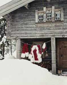 a happy new year's greeting card with santa hats and stockings hanging from a clothes line