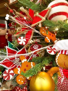 a christmas tree decorated with gingerbreads, ornaments and other holiday decorating items