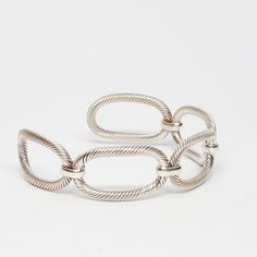 Twisted rope forms five oval links that are connected by a high shine polish clasp.  The contrast of the rope with the sleek clasps make this cuff a classy addition to any occasion.  The bracelet easily adjusts, and can be molded to comfortably fit different wrist sizes.  This cuff is .6 inches wide. Sterling Silver Cuff, Infinity Bracelet, 6 Inches, Heart Ring