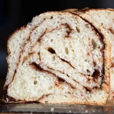 a loaf of cinnamon swirl bread sitting on top of a cutting board