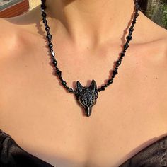 "Embrace your inner mystic with this stunning Wolf Black obsidian Necklace. Crafted in a gothic, boho style, this pendant showcases a powerful obsidian stone, known for its healing properties and spiritual connection. Perfect for the witchy jewelry lover, this unique piece will add a touch of enchantment to any outfit. Let this bewitching necklace be your new go-to accessory. 15-17\" Protection Grief  Truth  Grounding  Can be a gift for loved ones, friends or a treat to yourself.   Comes in a gift bag. PER ORDER you will receive a complimentary crystal that will be chosen intuitively and an oracle card.  Instructions for how to cleanse and charge will also be included. Please note that due to the fact these are natural stones, the colours may vary but will be equally as beautiful. Feel fre Mystical Choker Jewelry For Festivals, Black Wolf Design Jewelry For Gift, Mystical Necklaces For Halloween, Gothic Black Beads Halloween Jewelry, Mystical Choker Necklace For Festival, Mystical Halloween Festival Necklaces, Adjustable Gothic Onyx Jewelry, Mystical Halloween Festival Necklace, Bohemian Black Necklace For Halloween