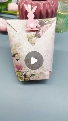 an origami rabbit is sitting on top of a vase