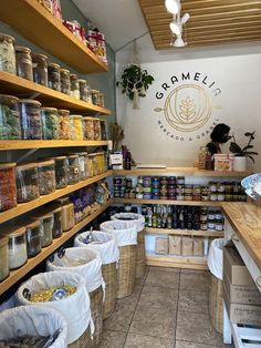 a store filled with lots of different types of food in baskets on the wall and shelves