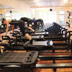 there are many people working out on the treadmills in this large gym room